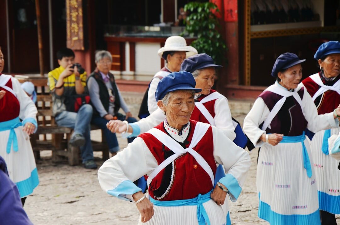 Senior couples dancing folk dance at a community hall