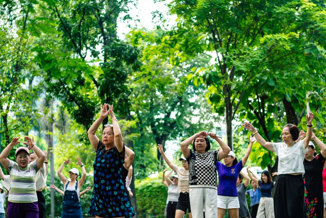 Seniors doing gentle group exercise and stretching outdoors